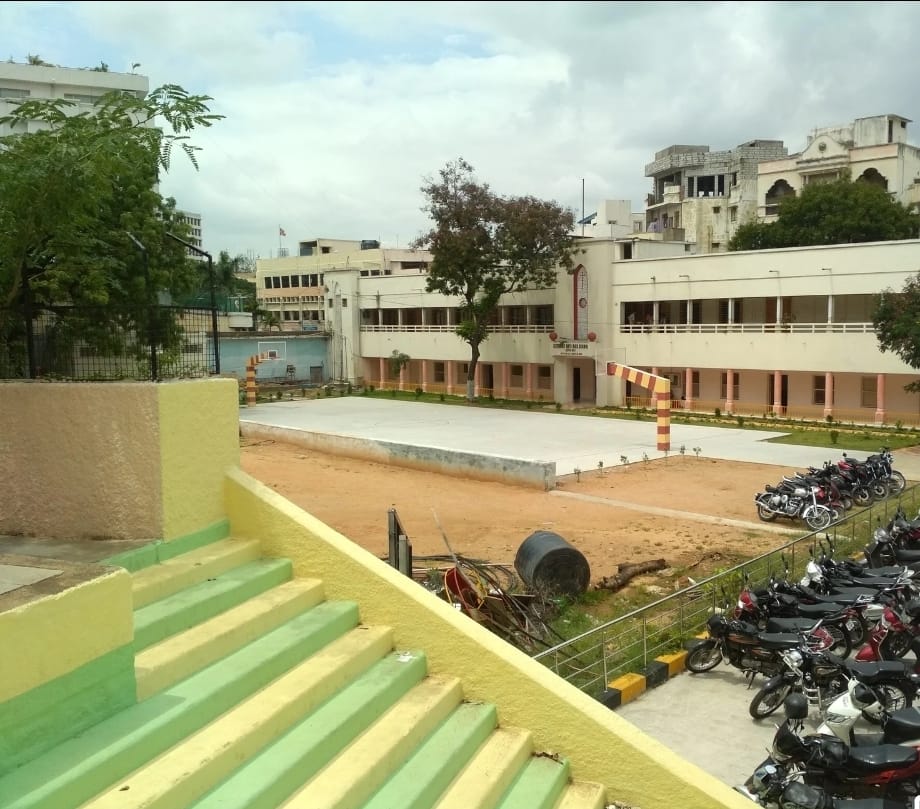 Wide view of the school campus, court and surrounding buildings